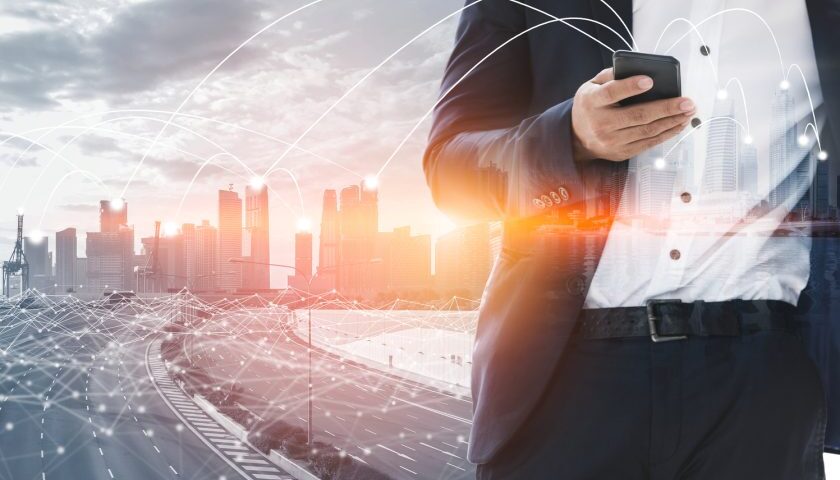 graphic collage of skyline with highway and businessman in foreground
