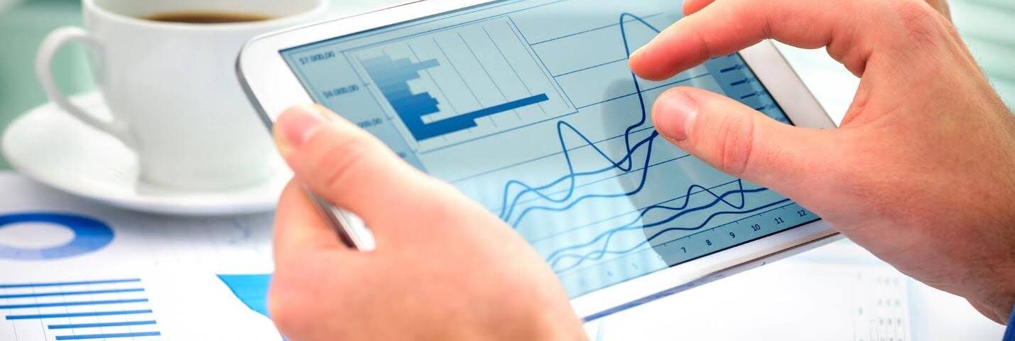 closeup of a person's hands on a digital tablet, navigating a chart